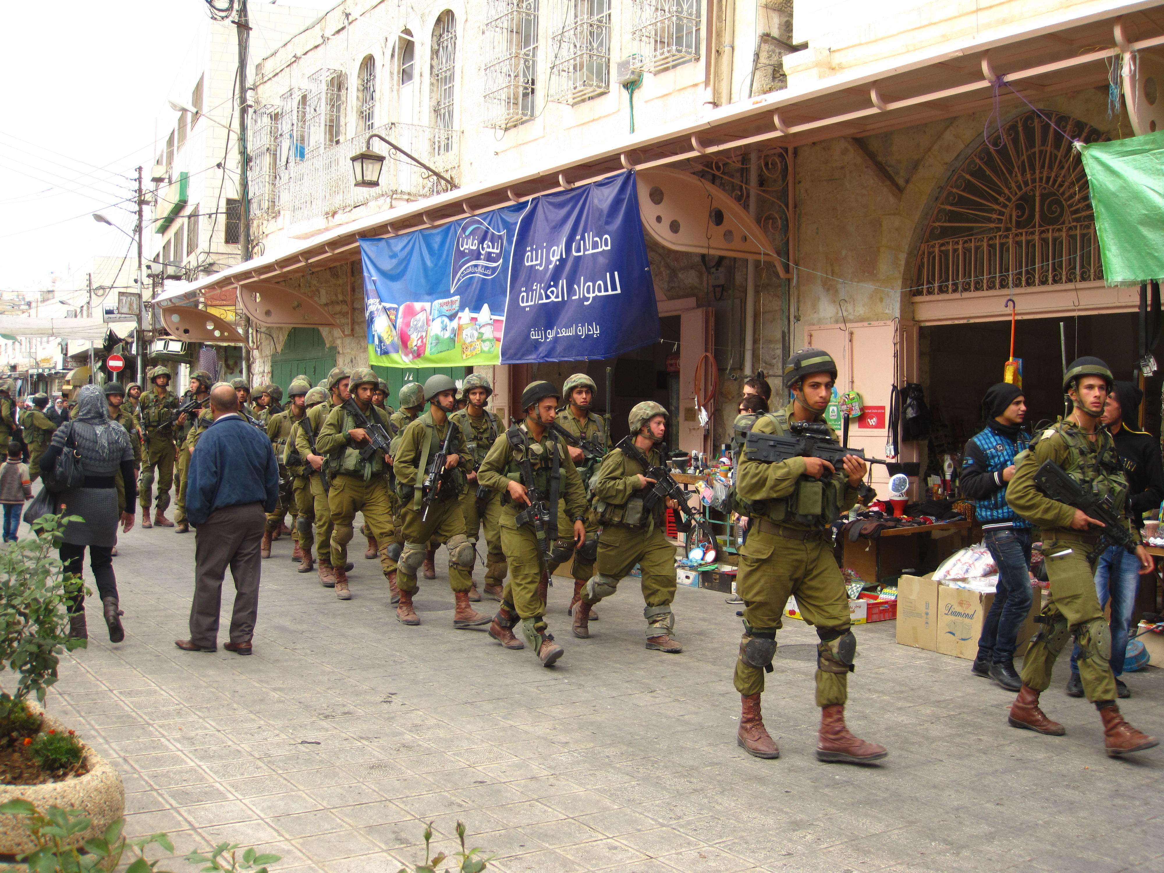 Soldiers clear old city streets in preparation for settler tours. Photo cred: Brona McDonald.